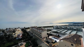 A coastal residential area with modern buildings, a road, and a view of the sea. - Sea and Pool View - South Costa, Torrox Costa, Torrox Costa (Torrox)