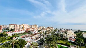 A coastal residential area with multi-story buildings, a beach, and palm trees. - Sea and Pool View - South Costa, Torrox Costa, Torrox Costa (Torrox)