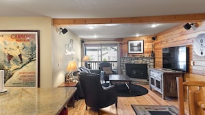 A cozy living room with a fireplace, wooden walls, and a television. - Cozy Mtn Retreat w/Fireplace | Mins to Village (Mammoth Lakes)