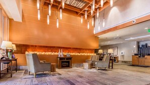 A lobby with a fireplace, seating area, and a reception desk.