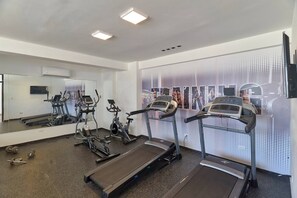 A gym with treadmills, elliptical machines, and a mirrored wall. - [The~Natural~Blues] @DowntownSD +Pool+Gym+Centric (Santo Domingo)