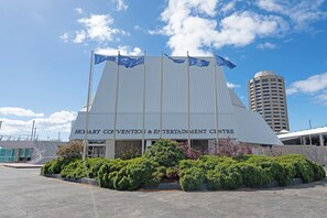 The exterior of the Hoyt Convention & Entertainment Centre with a modern architectural design, featuring a prominent entrance and surrounding greenery. - Scenic Sandy Bay Lookout in the Hills (Sandy Bay)