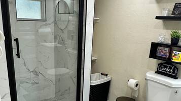 Shower, hair dryer, towels, toilet paper