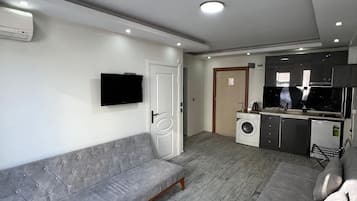 Deluxe Double Room Single Use | Living area | 120-inch Smart TV with satellite channels, video-game console, Netflix