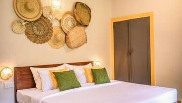 A bedroom with a wooden bed, a ceiling fan, and wall-mounted woven baskets.