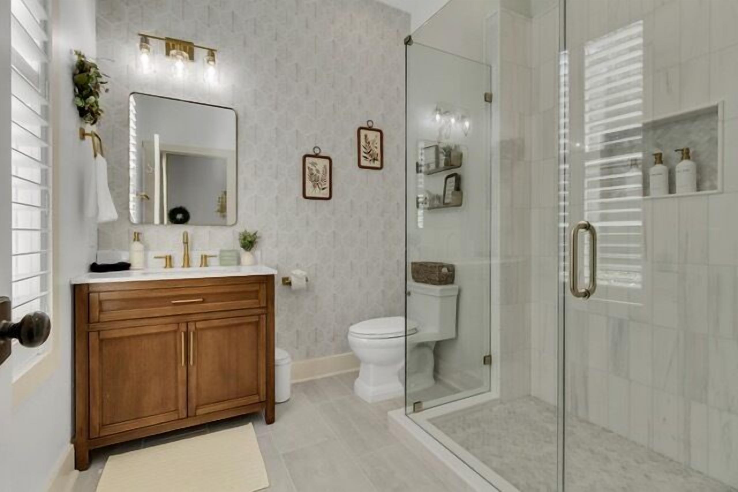 A modern bathroom with a wooden vanity, a glass shower enclosure, and a white toilet.