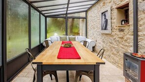 A covered dining area with a wooden table, chairs, and a red runner. - Charming Tuscany Villa w/ Private Infinity Pool (Castel del Piano)