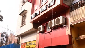 A building with a sign for 'Trinetra Home Stay' and a visible entrance. - Trinetra Homestay (Varanasi)