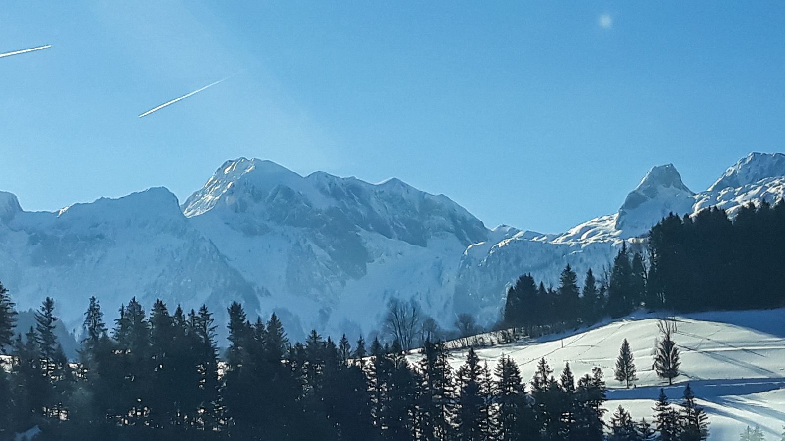 A snow-covered mountain landscape with a clear sky.