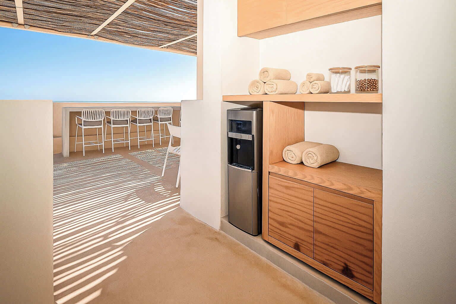 A modern bathroom with a built-in shower, wooden cabinets, and a view of the outdoor seating area.