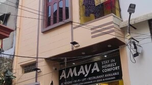 A multi-story building with a sign for 'AMAYA' indicating it is a hotel. - Amaya Deluxe (Varanasi)