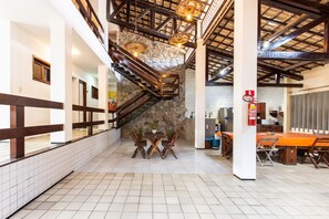A spacious interior with a staircase, a dining area, and a kitchen.