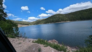 A lake surrounded by forested hills. - Newly constructed, charming, ski-on ski-off condo (Beaver)