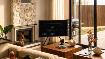 Deluxe Villa, Lake View | Living area | 55-inch Smart TV with digital channels