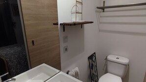 A bathroom with a white sink, a toilet, and a shower area. - Very cocoon garden hut - access to our magnificent Gîte. Near Provins (Savins)