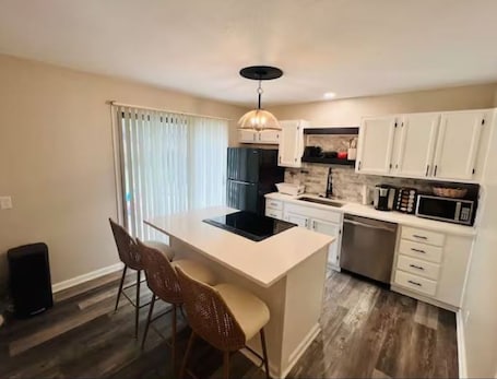 Fridge, microwave, oven, stovetop. KC Family Retreat • Modern, Safe & Spacious • Minutes to Arrowhead & Downtown