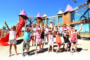 A group of children at a playground with various play structures, including a slide and climbing areas. - KLASSIK 2-Bedroom Mobile Home "DIMANCHE" - No Air Conditioning - Sleeps 5 (SERIGNAN)