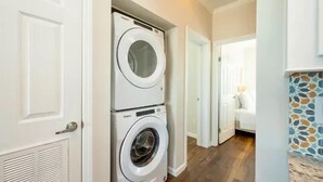 A laundry room with two stacked front-loading washing machines. - Waterfront 2BR, Dock,Golf Cart, trailer parking,Open Water Views Venture Out 320 (Cudjoe Key)