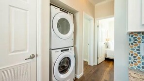 A laundry room with two stacked front-loading washing machines. - Waterfront 2BR, Dock,Golf Cart, trailer parking,Open Water Views Venture Out 320 (Cudjoe Key)