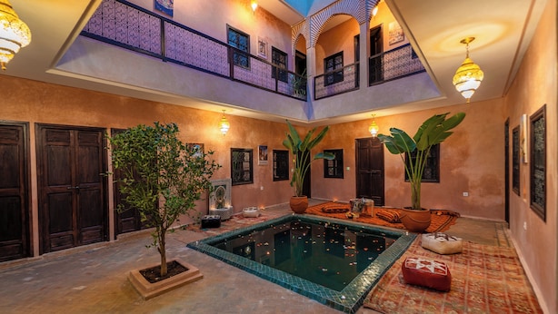 A spacious courtyard with a swimming pool, potted plants, and a traditional architectural design. - Riad Lalla Fatima  (Marrakech)