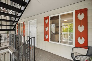 A hotel corridor with a staircase, a door labeled '5', and a window with heart-shaped cutouts. - 1BD King Condo – Walking Distance to PCMR on Park Ave (Park City)