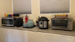 A kitchenette with a microwave, toaster oven, and electric pressure cooker. - South Seattle, Free Parking, Private Entrance and 3/4 Bath, Q Bed, Free Laundry. (Seattle)