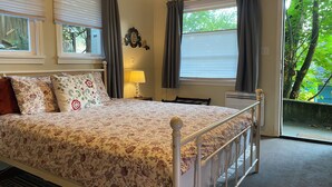 A bedroom with a bed, a nightstand, a lamp, and a window with curtains. - South Seattle, Free Parking, Private Entrance and 3/4 Bath, Q Bed, Free Laundry. (Seattle)