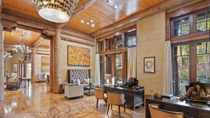 A spacious lobby with a wooden floor, a large chandelier, and a reception desk. -  Bachelors Gulch Condo- 2 Bed and 2 1/2 bath. (Avon)