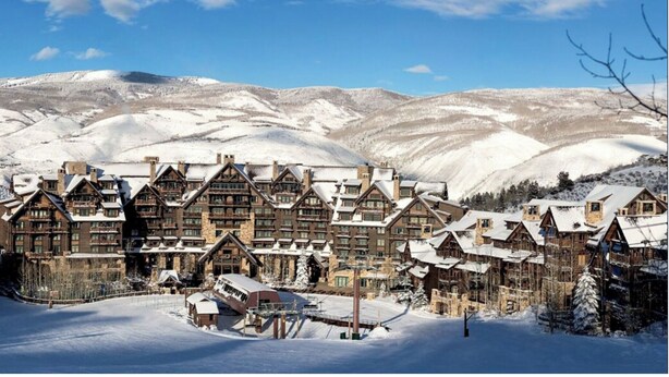 A log cabin-style hotel with multiple buildings, surrounded by snow-covered hills. -  Bachelors Gulch Condo- 2 Bed and 2 1/2 bath. (Avon)