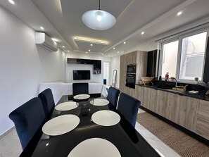 Open-plan kitchen and dining area with modern design and plenty of natural light. - Panoramic Penthouse Stay • Front & Back Terraces (Ta` Sannat)