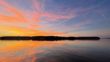 A calm lake with a sunset sky.