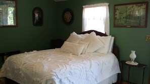 Une chambre à coucher avec un lit, une fenêtre et une horloge murale.