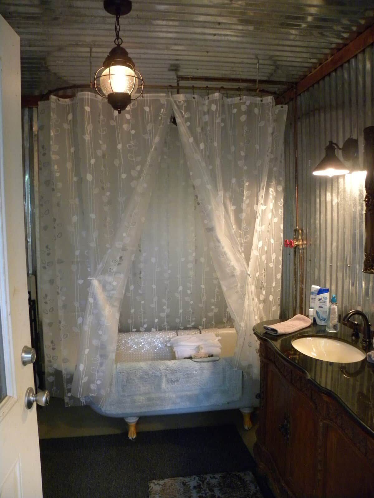 A bathroom with a bathtub, a sink, and a mirror.