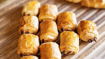 A wooden surface with several golden-brown pastries.