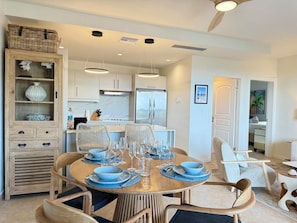 A modern kitchen with white cabinets, a built-in oven, and a refrigerator. - NEW ! Elegant and modern 2-Bedroom, with marina and garden view in Porto Cupecoy (Sint Maarten)