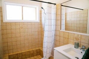 Shower, hair dryer, towels, toilet paper