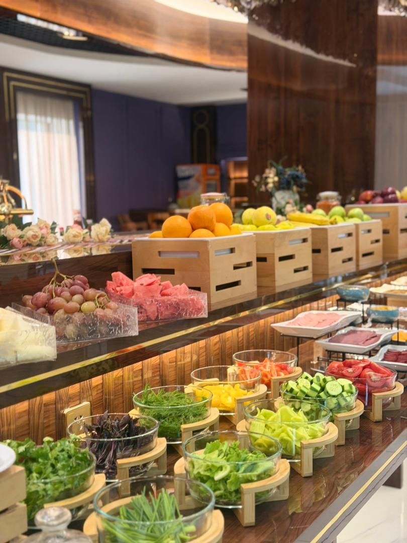 A buffet with various food items and beverages.