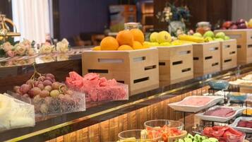 A buffet with various food items and beverages.