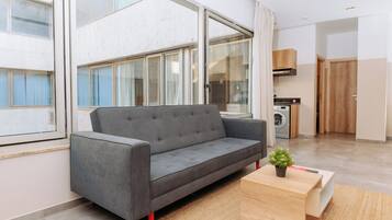 Deluxe Apartment, Kitchenette | Living area | 55-inch Smart TV with digital channels, streaming services