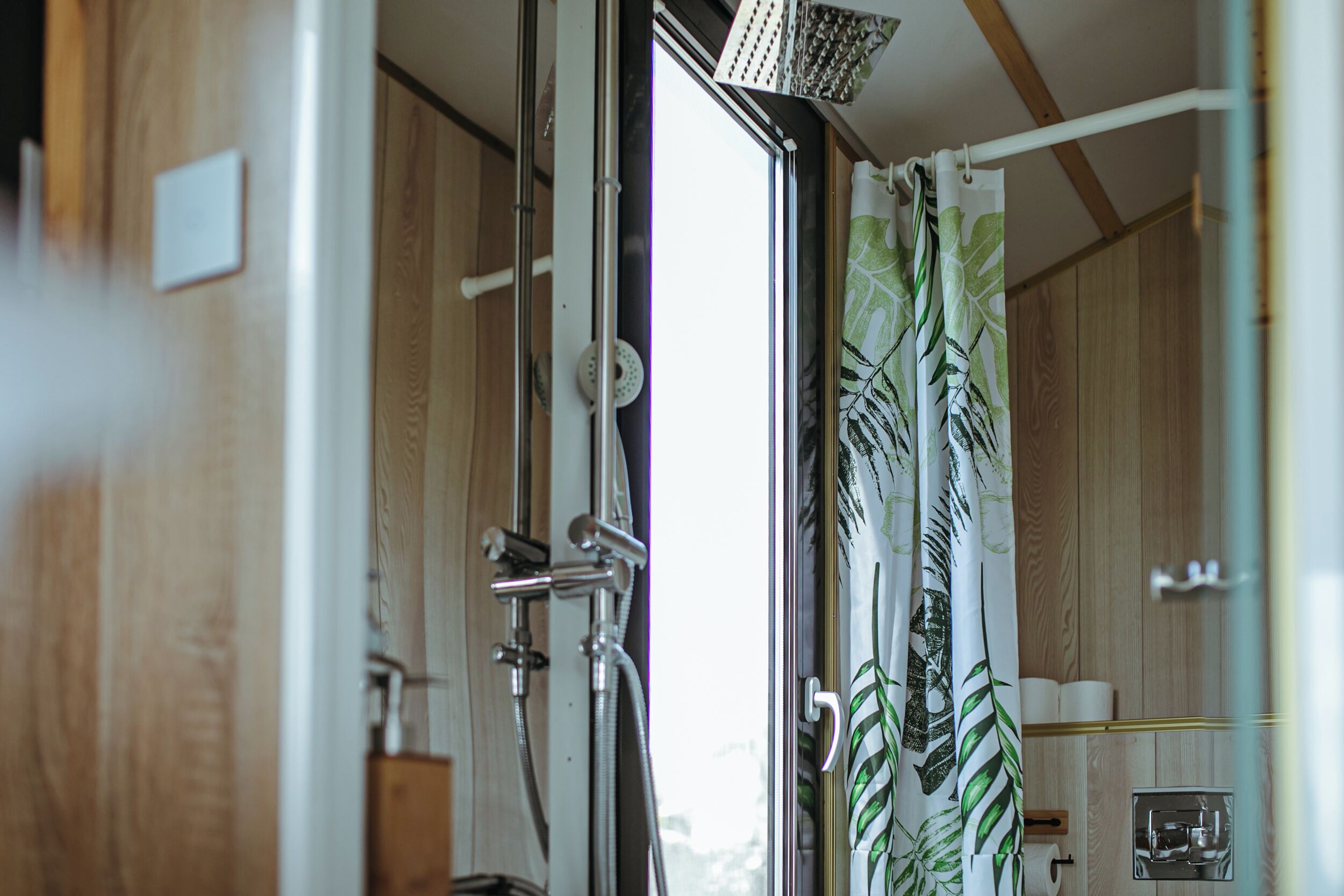 A bathroom with a shower, a toilet, and a sink.