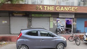 A small car parked in front of a building with a sign that reads "85 THE GANGES". - AniGanges - Quiet 1-Bedroom AC Retreat in Veerbhadra, Rishikesh (Veerbhadra)