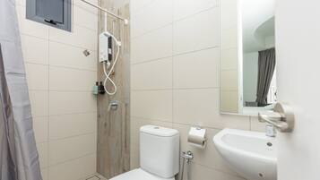 Un baño moderno con inodoro, ducha y lavamanos.