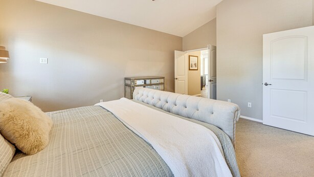 A bedroom with a bed, a ceiling fan, a dresser, and a door. - 4,500-sq-ft Retreat w/ Hot Tub in Colorado Springs (Colorado Springs)