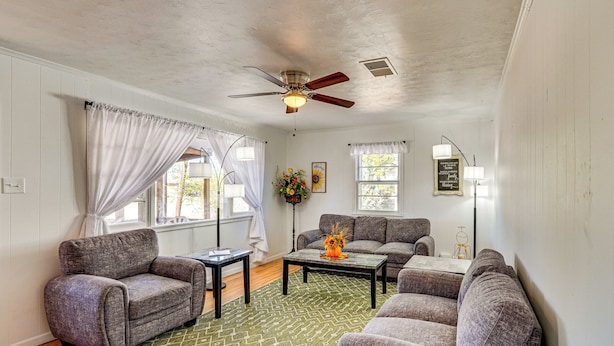 A living room with a ceiling fan, two sofas, a coffee table, and a patterned rug. - Near Hunting Grounds: Aspermont Home w/ Yard (Aspermont)