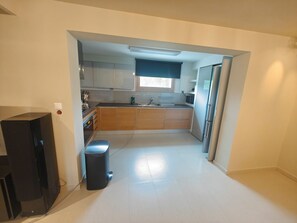 A compact kitchen with a refrigerator, sink, and cabinets. - Serene,  spacious 4-bedroom villa in beautiful Pelion, located on the west side (Artemis)