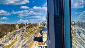 A view of a cityscape with multiple highways and a prominent green-roofed building in the foreground. - Warszawa, Wolska 2-3 osobowy apartament z klimatyzacją (Warszawa)