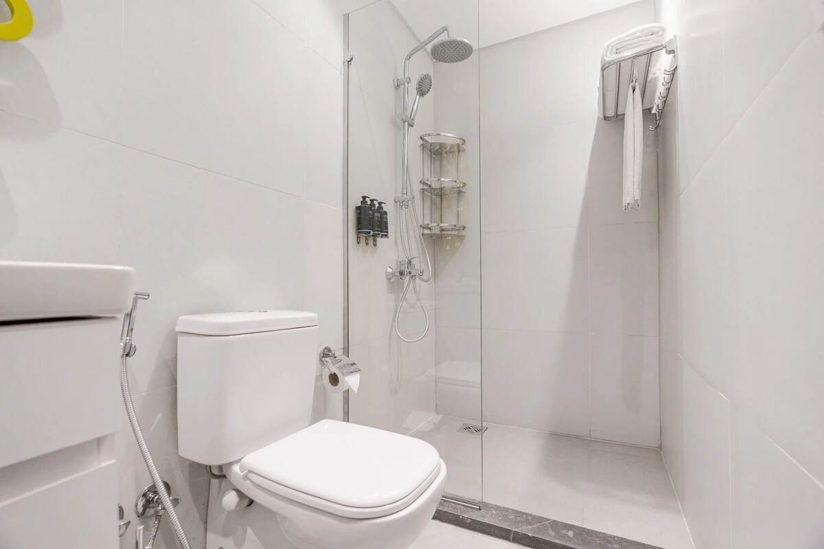 Ein modernes Badezimmer mit Toilette, Dusche und Duschkabine.