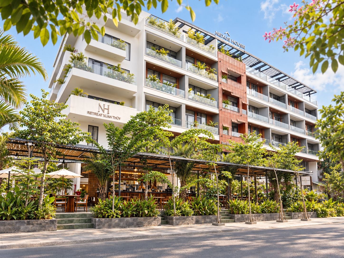 A multi-story hotel with outdoor seating and greenery.