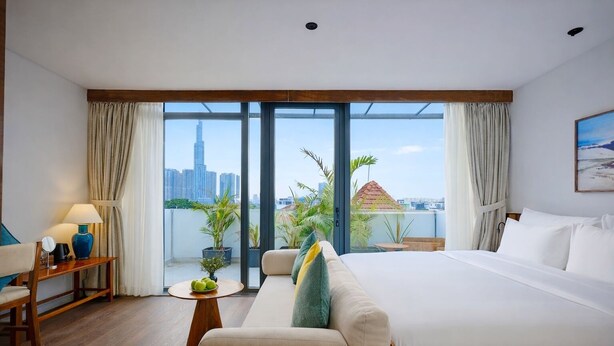 A hotel room with a large bed, a sofa, a small table with a lamp, and a view of the cityscape through large windows. - Nexus House Retreat Xuan Thuy (Ho Chi Minh City)