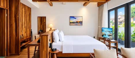 Een hotelkamer met een bed, een bureau, een stoel, een televisie en een schilderij.